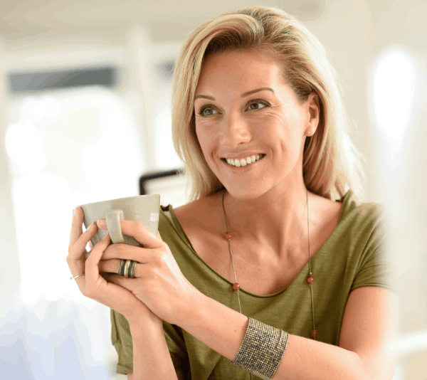 A woman holding a cup of coffee.